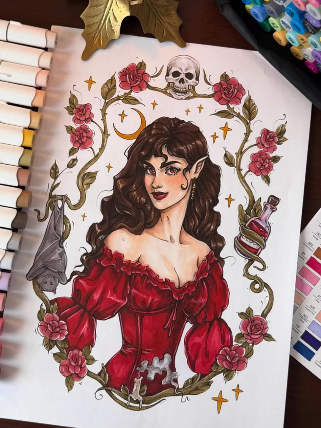 kolorowanka cyfrowa przedstawiająca portret wampirzycy w stylu whimsical, w kwiecistej ramce z nietoperzem, gwiazdami i księżycem